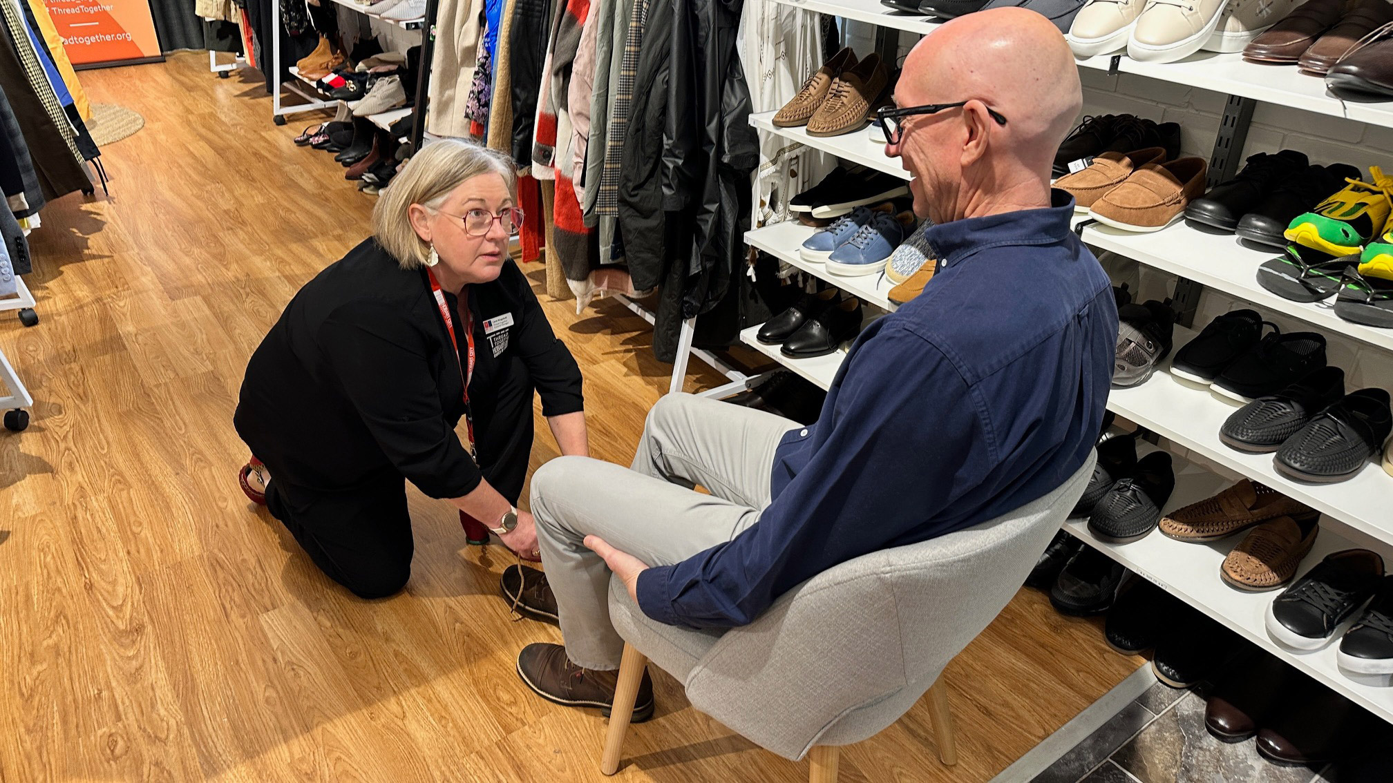 Man being fitting for new shoes